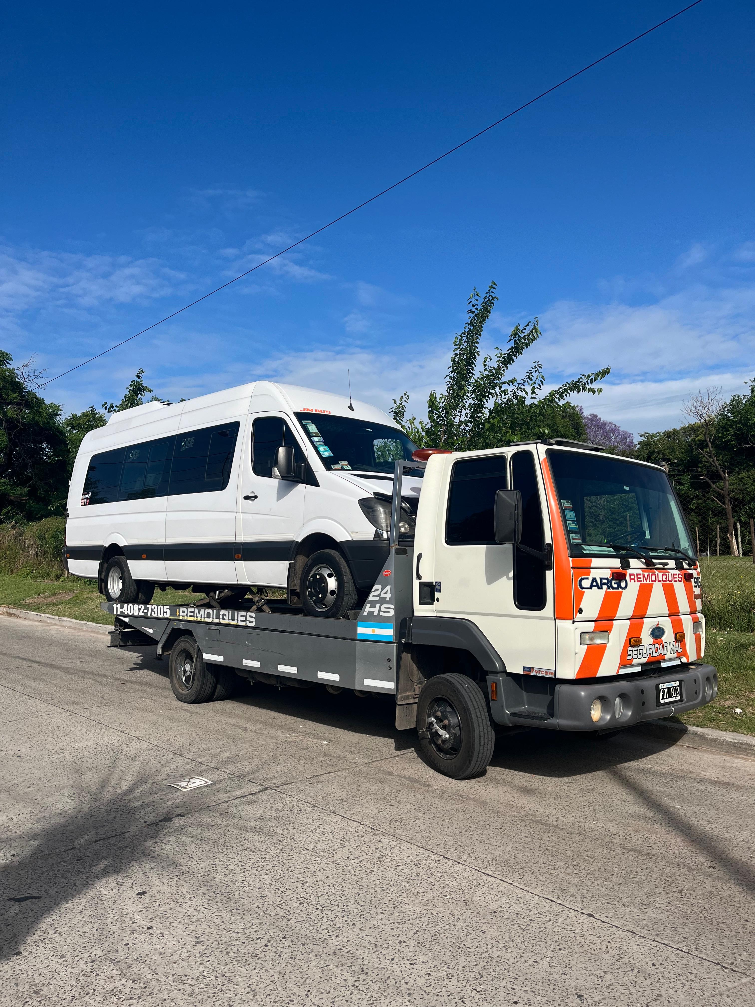 Camión grúa remolcando una van